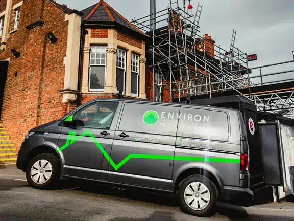Environ Restoration Services van parked near a building under renovation with scaffolding, highlighting expertise in Section 20 works and property restoration in London.