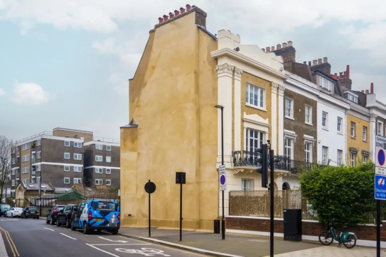 Historic period property in Chiswick, London, showcasing architectural restoration with traditional features and modern enhancements, surrounded by urban setting and vehicles.