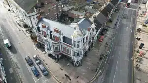 Aerial view of a historic building in London, showcasing intricate architectural details and surrounding streets, relevant to discussions on heritage restoration and property maintenance.