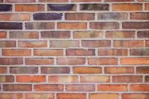 Brick wall texture showcasing various shades and patterns, relevant to discussions on brick cleaning and maintenance.