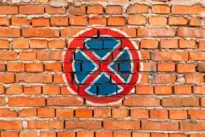Graffiti symbol on a brick wall, illustrating the challenges of maintaining brick surfaces and the need for effective cleaning techniques.