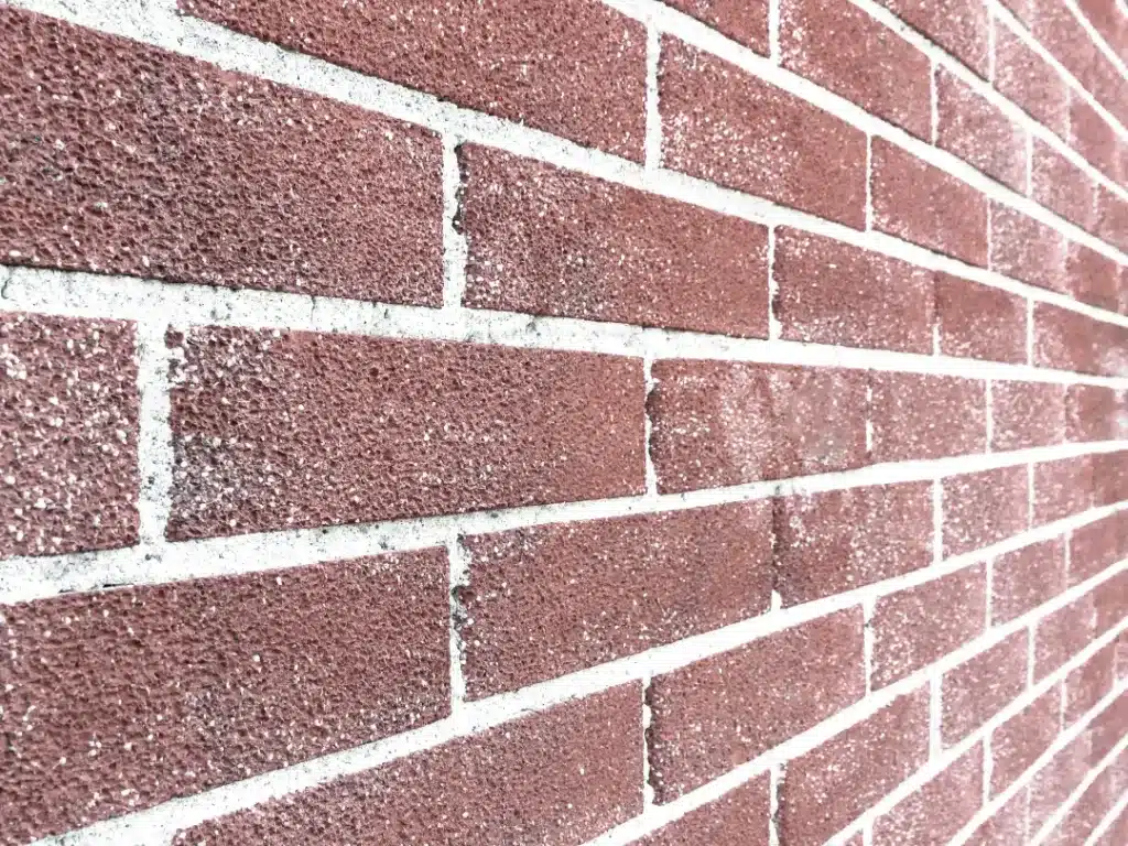 Close-up of a clean brick wall, showcasing the texture and colour of the bricks, relevant to seasonal brick cleaning and maintenance tips.